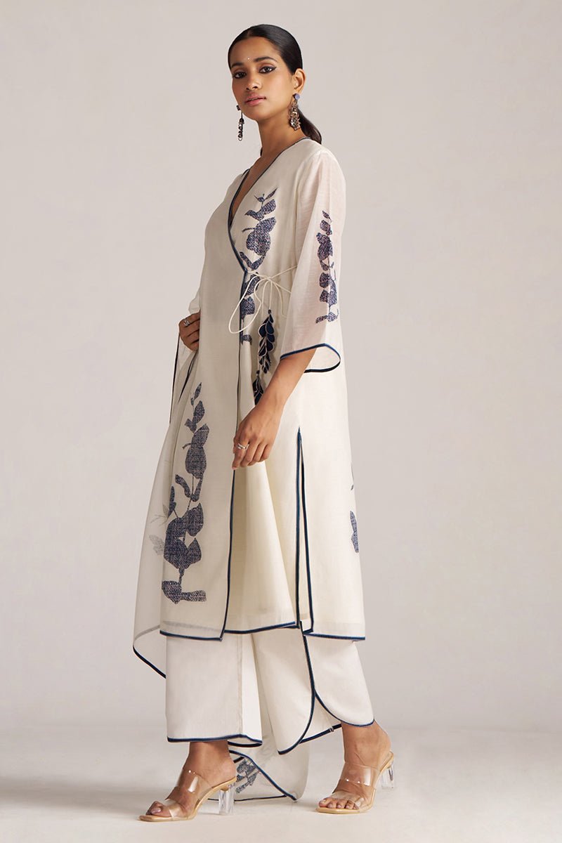 Woman wearing a beige outfit with floral patterns on a plain background | Ivory and Navy Blue Pure Chanderi Kurta Set