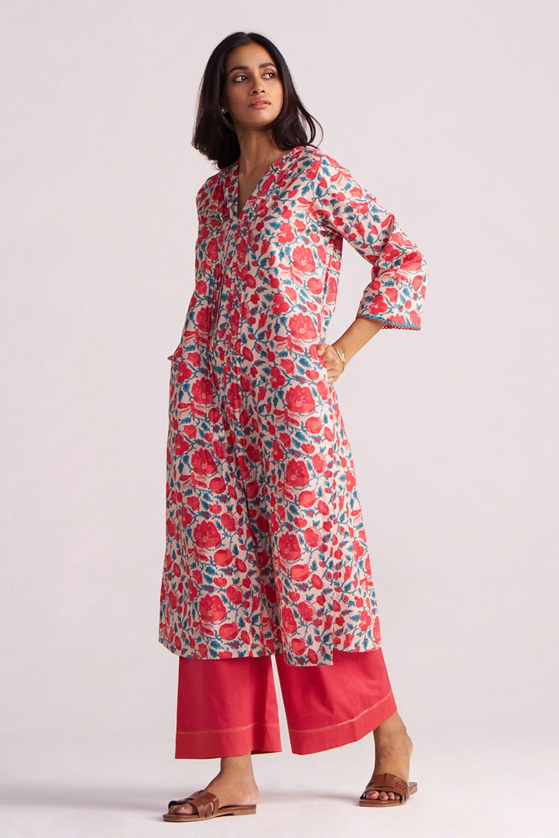 Woman wearing a Beige and Red Cotton Print Co-ord Set on a light gray background