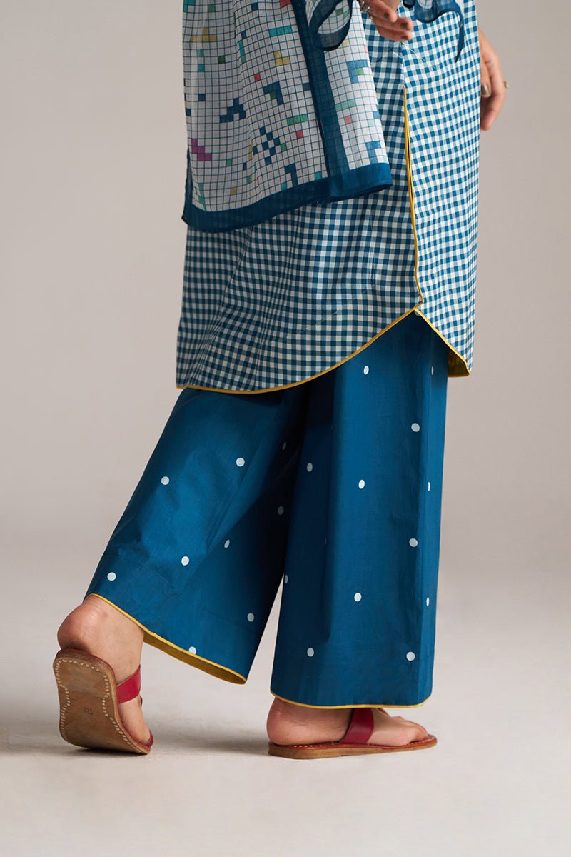 Person wearing a blue checkered top and blue pants with white polka dots on a neutral background | Blue and White Mul Mul Checkard Co Ord Set with Stole