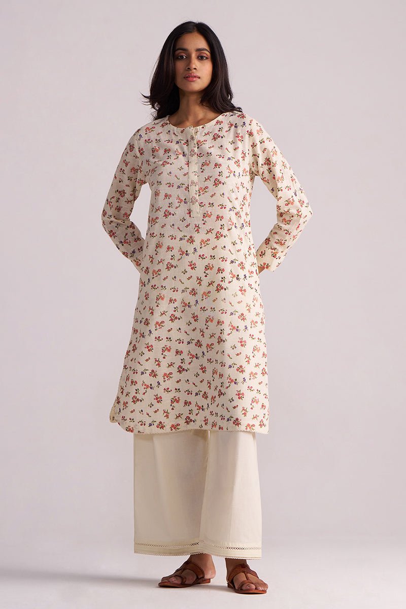 Woman wearing a Cream and Pink Tiny Floral Hand-Print Co-ord Set on a light gray background