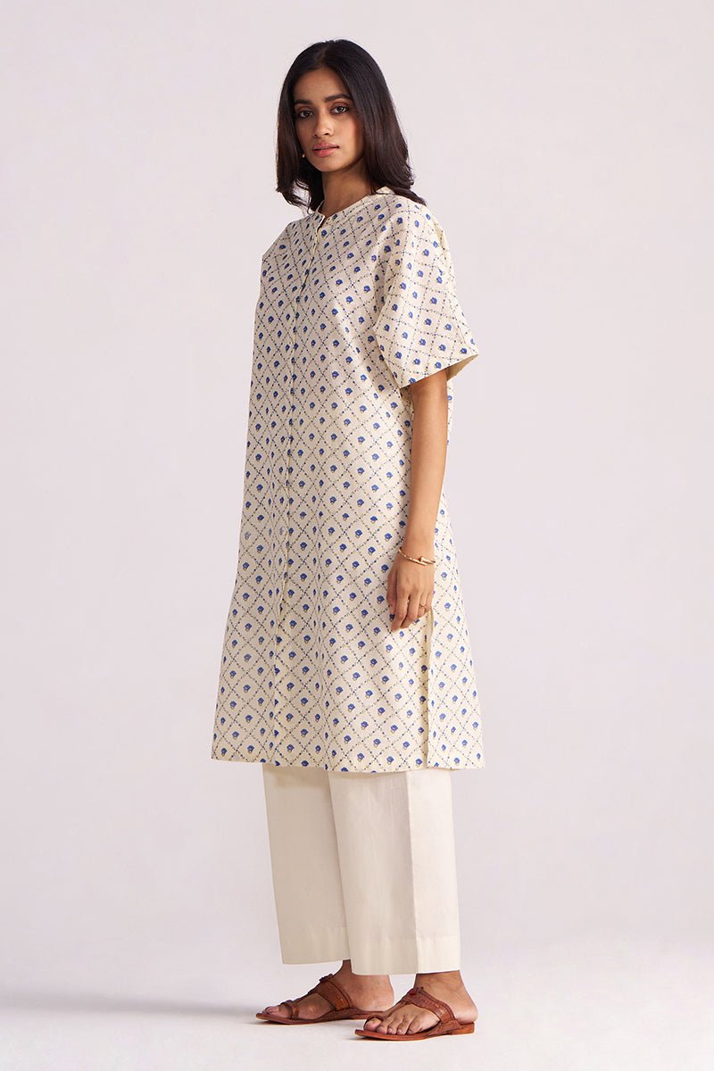 Woman wearing a Cream and Blue Small Flower Hand-Print Cotton Linen Co-ord Set on a light gray background