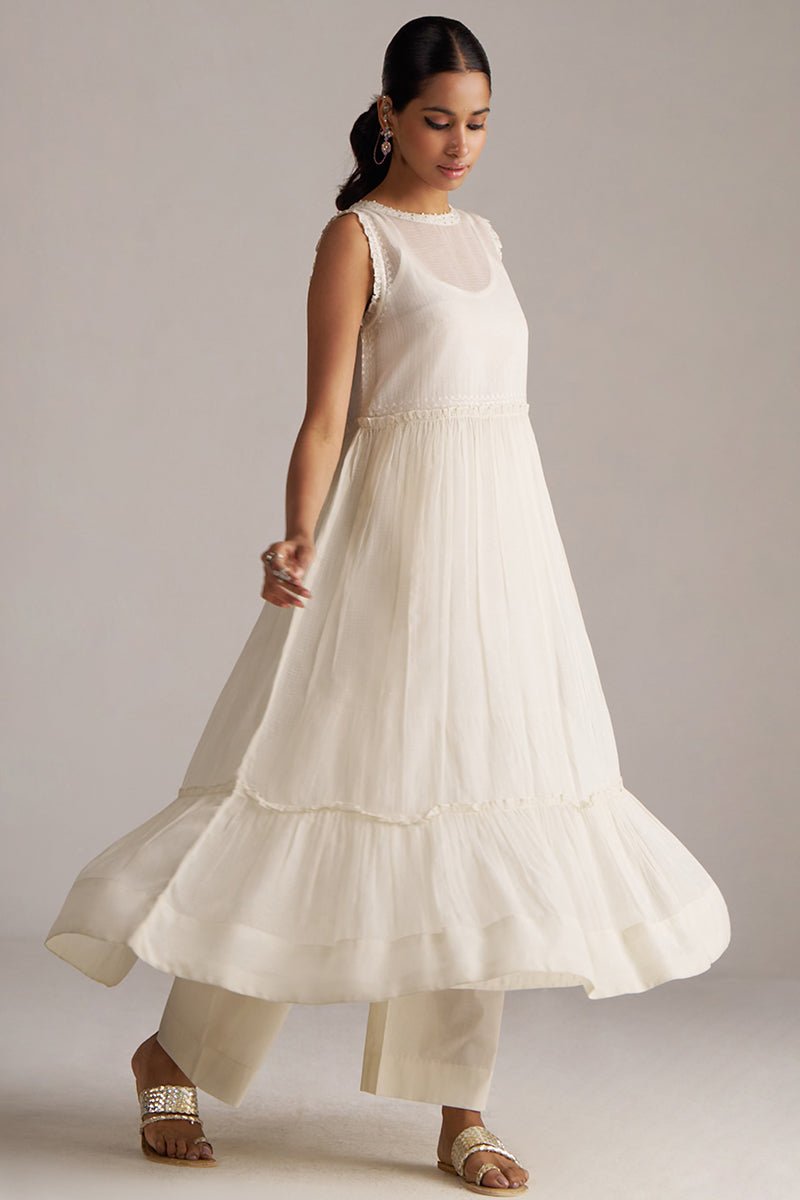 Woman wearing a white dress with a plain background | Ivory Kota Silk Kurta Set for Women