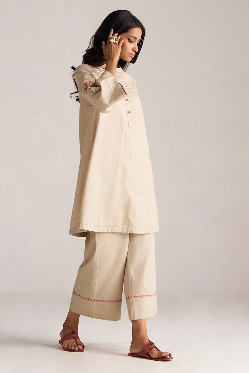 Woman wearing a beige traditional outfit with a plain background | Brown Rice Co-ord Set – Solid Ethnic Wear | Ganga Fashions