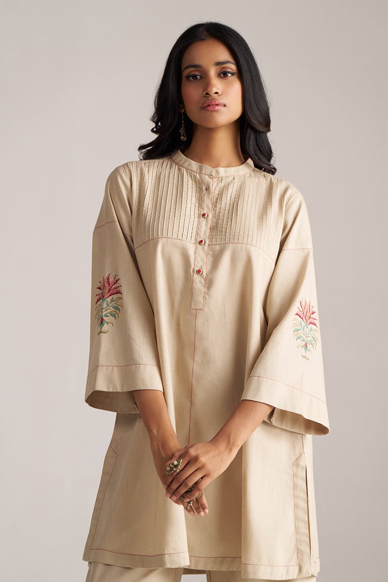 Woman wearing a beige kurta with floral embroidery on a plain background | Brown Rice Co-ord Set – Solid Ethnic Wear | Ganga Fashions