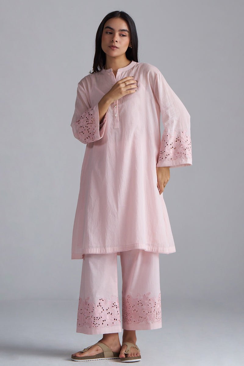 Woman wearing a light pink traditional outfit with intricate embroidery on a gray background, Crystal Pink Mul Mul Co-ord Set for Women | Ganga Fashions