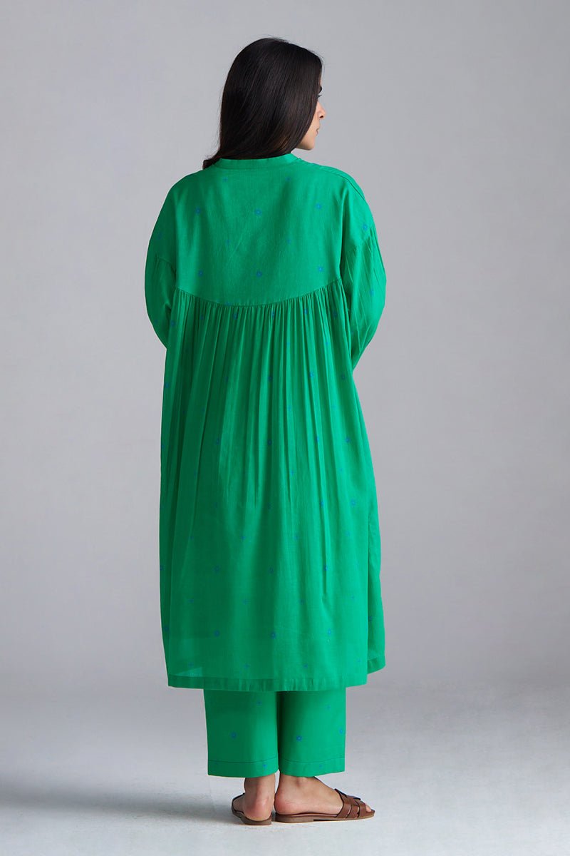 Person wearing a green outfit standing against a plain background, Holly Green Mul Mul Co-ord Set for Women | Ganga Fashions