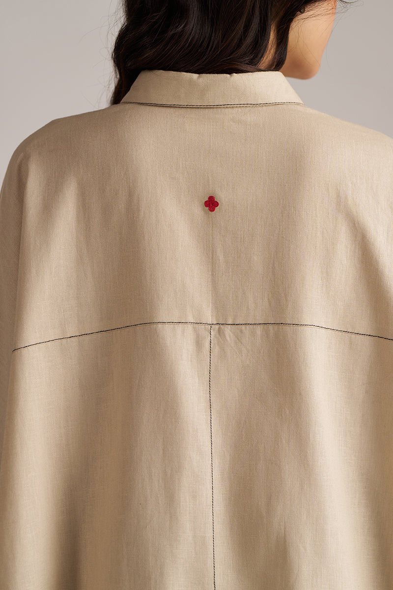 Close-up of a beige jacket with a red button on a neutral background | Brown Rice Co-ord Set for Women | Rangmanch | Ganga Fashions