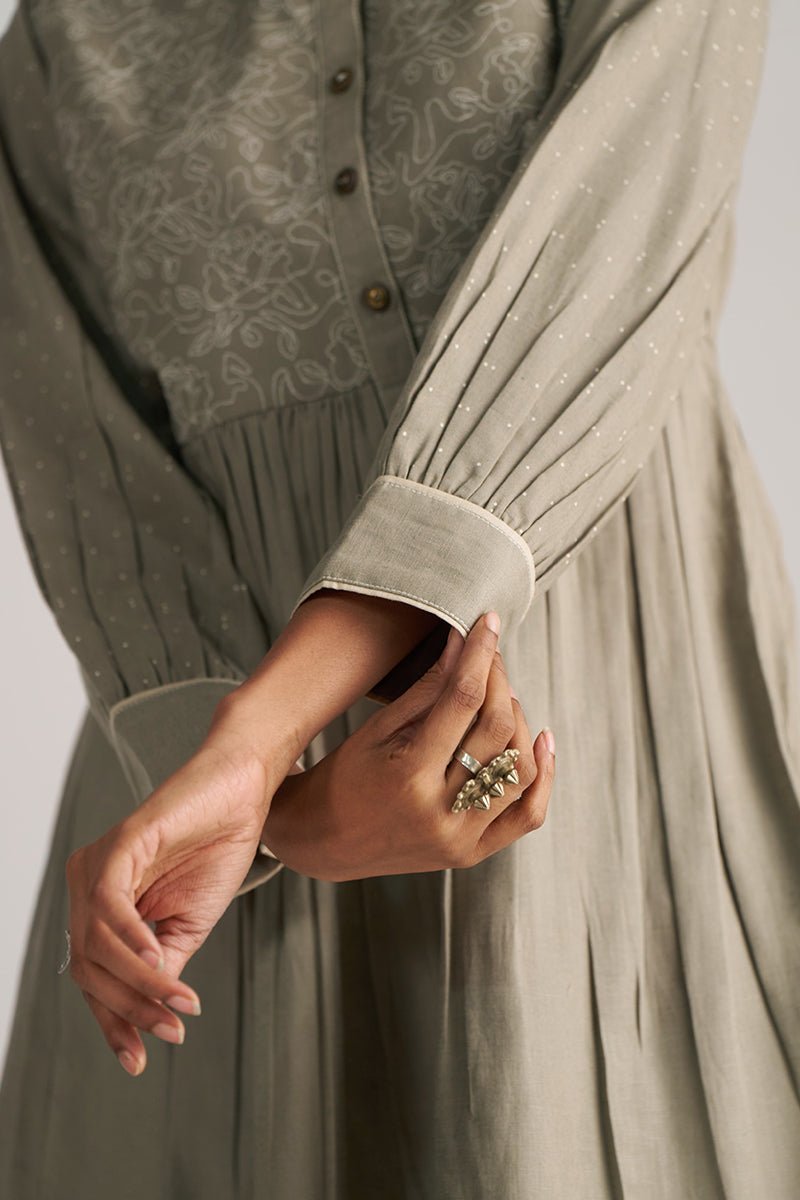 Close-up of a person wearing a long, light-colored dress with a patterned cardigan. | Buy Grey Co-ord Set for Women | Rangmanch Collection - Ganga Fashions