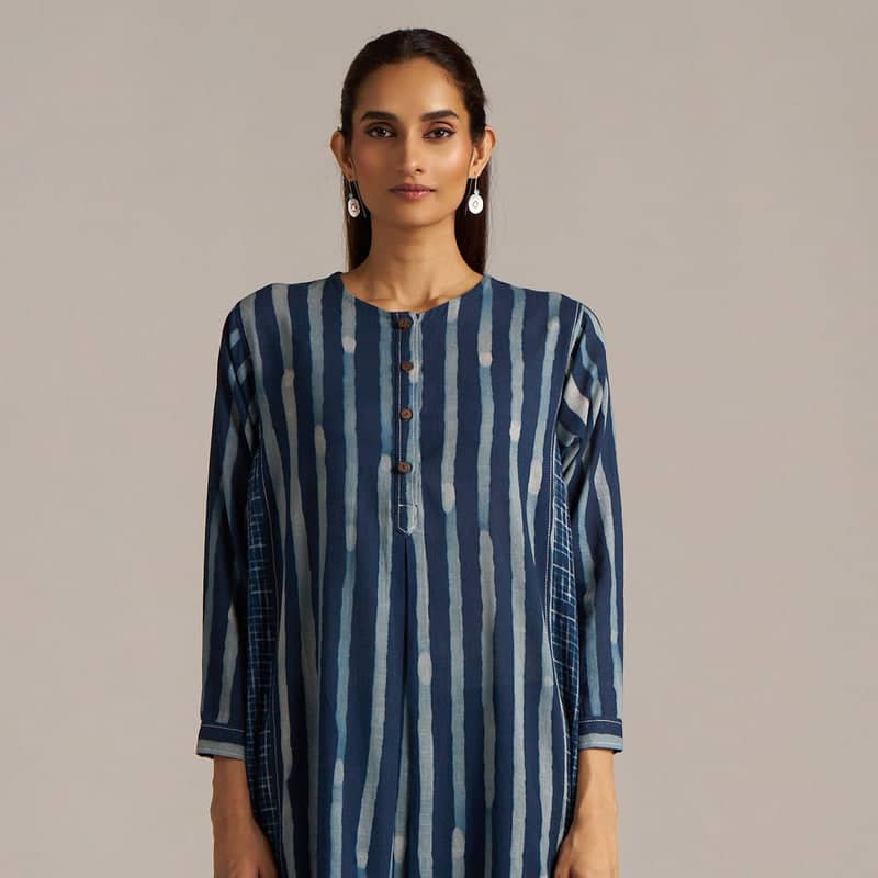 Woman wearing a blue and white striped dress against a beige background | check balance co-ord sets