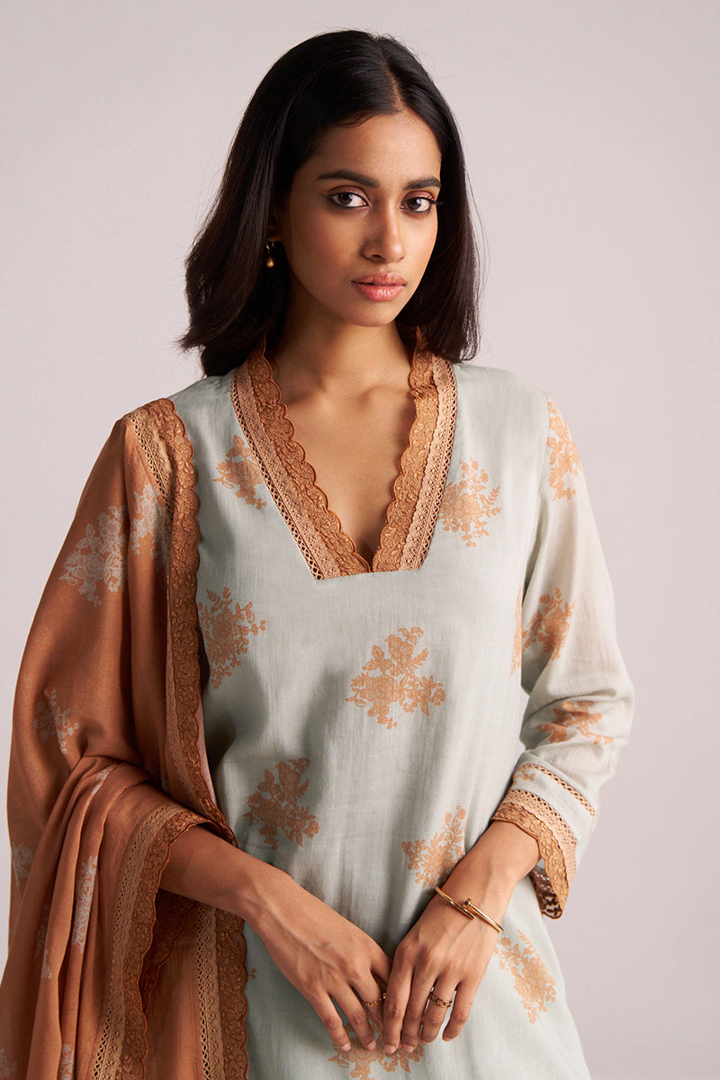 Woman wearing a Grey-Rust Mul Kurta Set with brown embroidery against a plain background