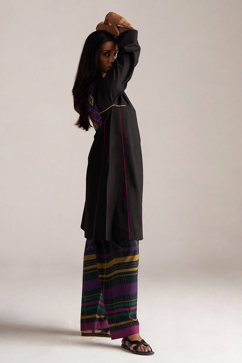 Woman wearing a black outfit with colorful striped pants on a plain |background | Black Multi Colour Checkard Co Ord Set