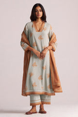 Woman wearing a Grey-Rust Mul Kurta Set with a brown dupatta on a plain background