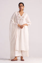 Woman wearing a Ivory Embroidered Kurta Set with a plain background