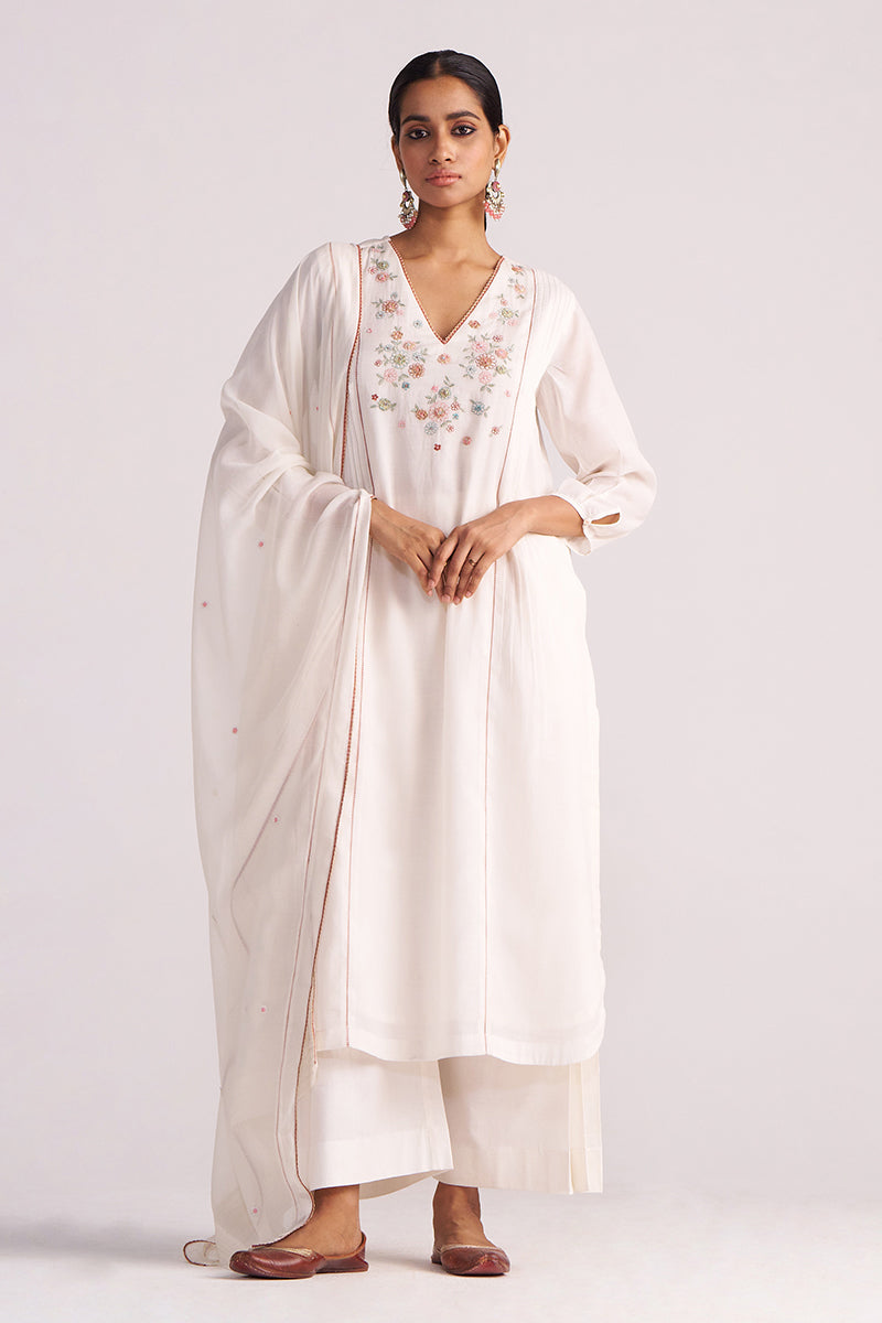 Woman wearing a Ivory Embroidered Kurta Set with a plain background