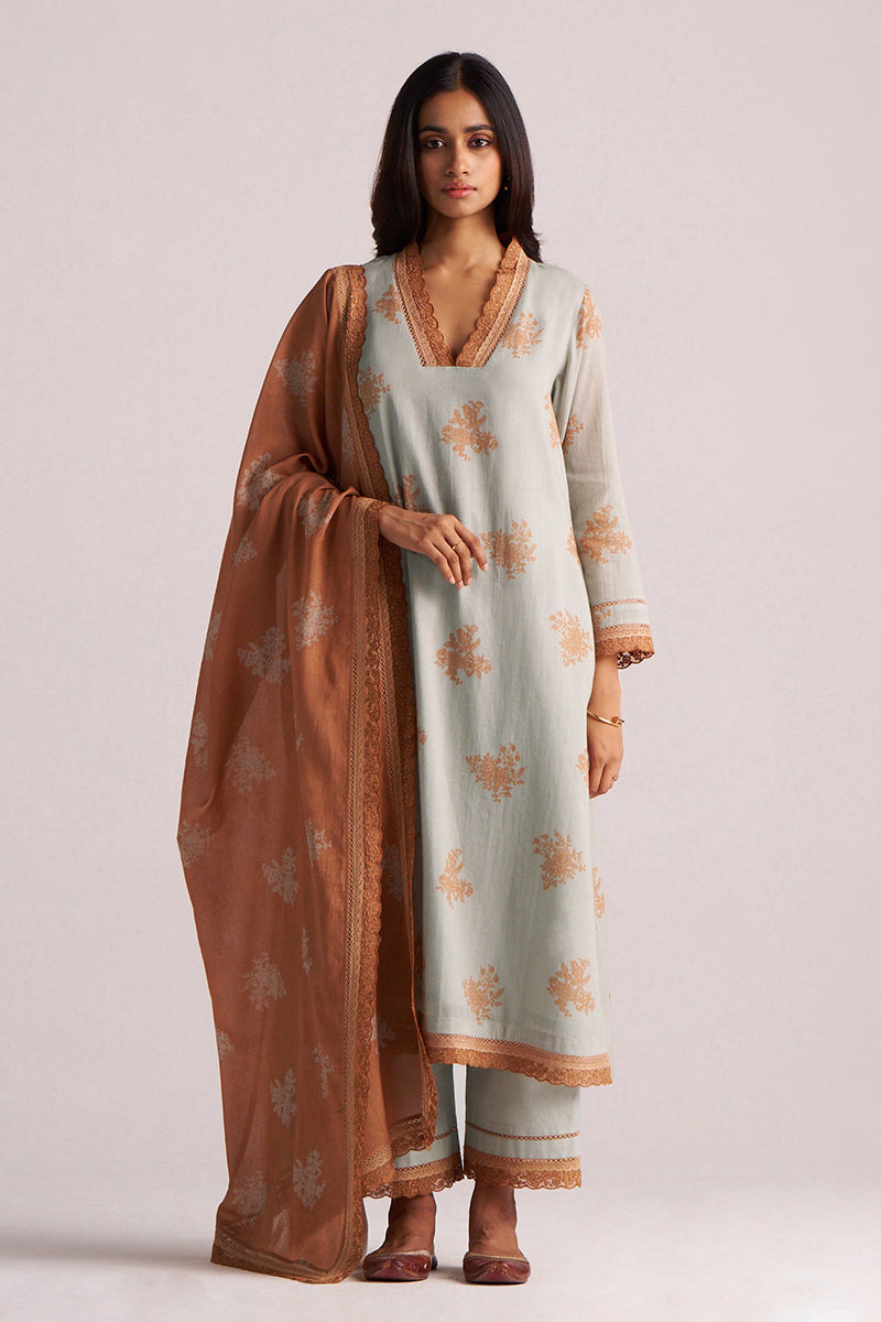 Woman wearing a Grey-Rust Mul Kurta Set with a brown dupatta on a plain background