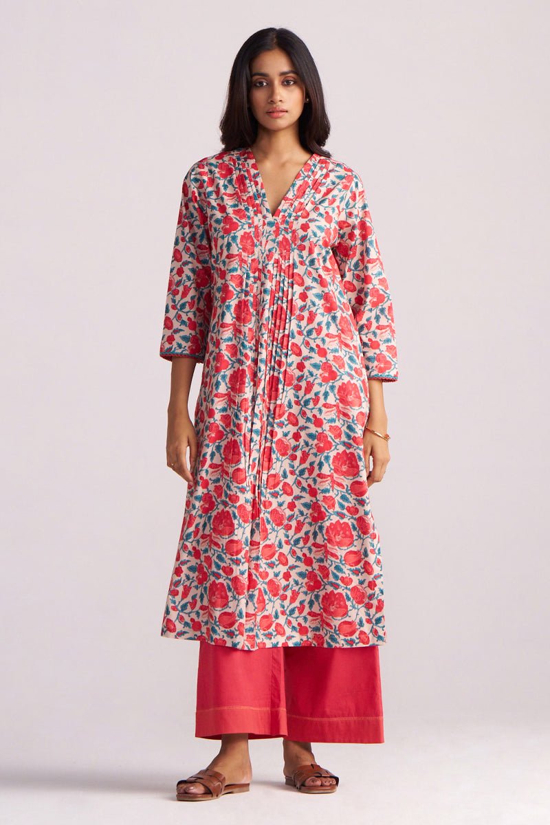 Woman wearing a Beige and Red Cotton Print Co-ord Set a plain background
