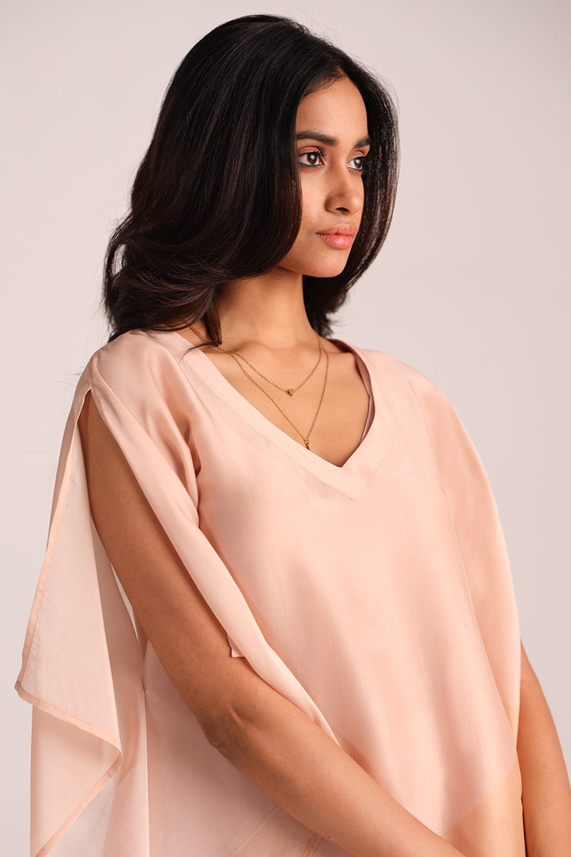 Woman wearing a Spanish Villa Silk Kaftaan Co-ord Set against a plain background