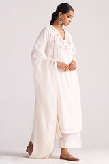 Woman wearing a Ivory Embroidered Kurta Set with a plain background