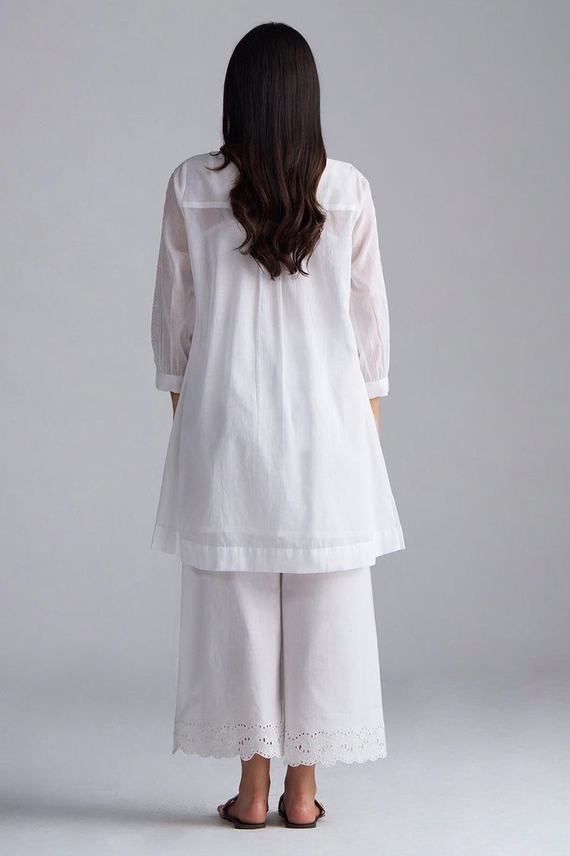 Woman wearing a white embroidered outfit on a plain background, White Mul Mul Co-ord Set for Women | Rangmanch | Ganga Fashions