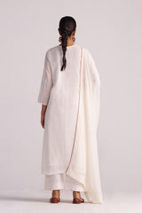 Woman wearing a Ivory Embroidered Kurta Set with a drape on a plain background