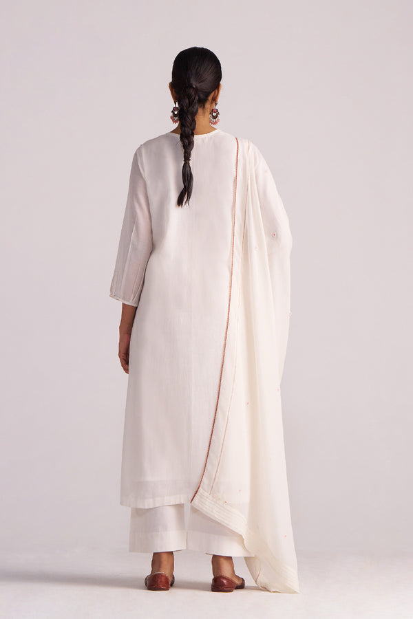 Woman wearing a Ivory Embroidered Kurta Set with a drape on a plain background