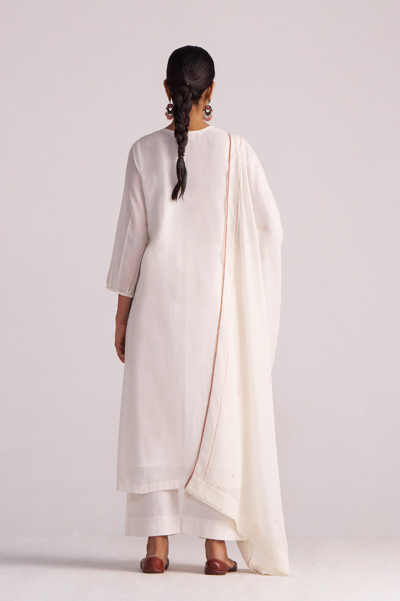 Woman wearing a Ivory Embroidered Kurta Set with a drape on a plain background