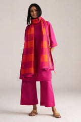 Woman wearing a bright pink outfit with a matching scarf on a plain background | Fuchsia Solid Kurta with Mul Mul Dupatta