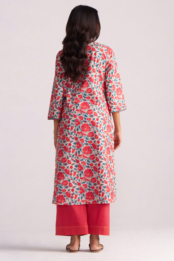 Woman wearing a Beige and Red Cotton Print Co-ord Set a plain background