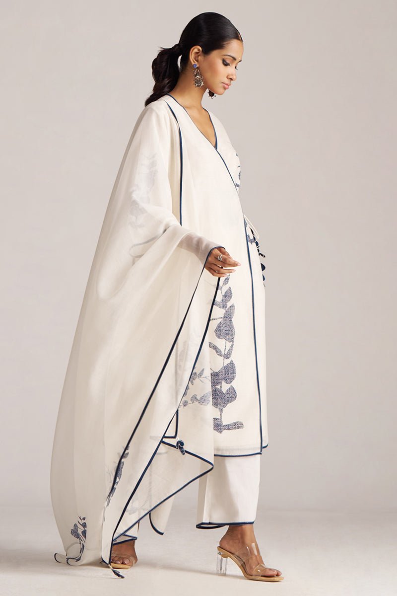 Woman wearing a white saree with blue patterns on a plain background | Ivory and Navy Blue Pure Chanderi Kurta Set