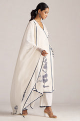 Woman wearing a white saree with blue patterns on a plain background | Ivory and Navy Blue Pure Chanderi Kurta Set