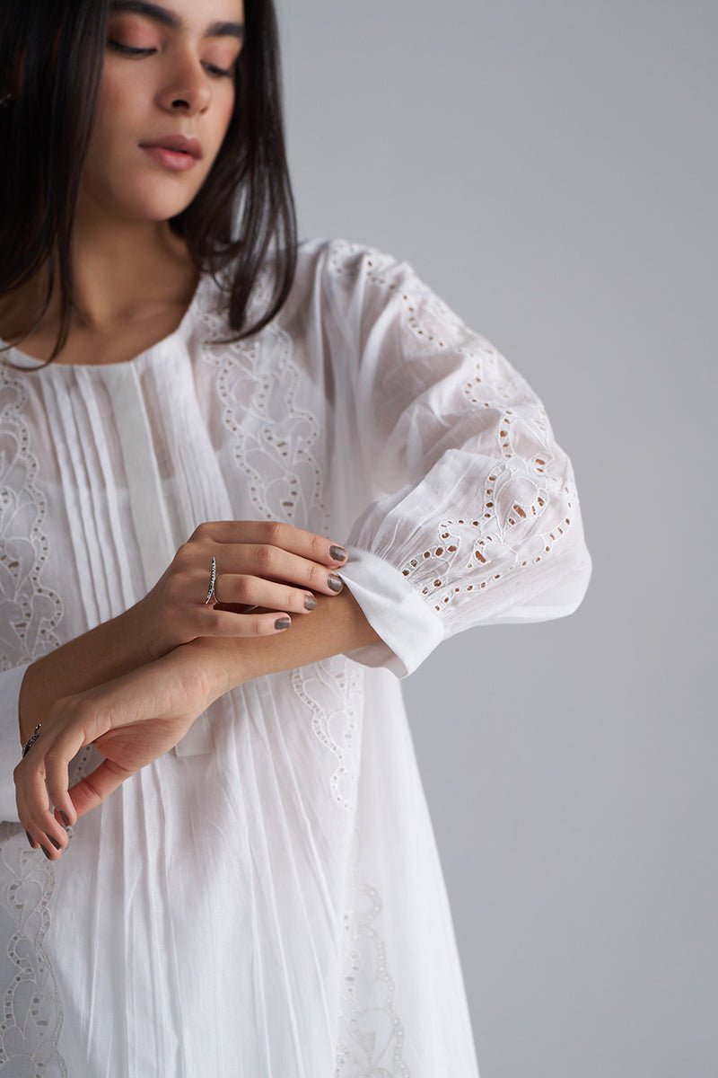 Woman wearing a white dress with intricate detailing on a gray , White Mul Mul Co-ord Set for Women | Rangmanch | Ganga Fashionsbackground