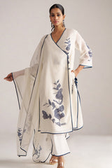 Woman wearing a white outfit with blue floral embroidery on a plain background | Ivory and Navy Blue Pure Chanderi Kurta Set