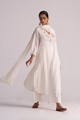 Woman wearing a Ivory Embroidered Kurta Set with a plain background