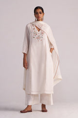 Woman wearing a Ivory Embroidered Kurta Set on a plain background