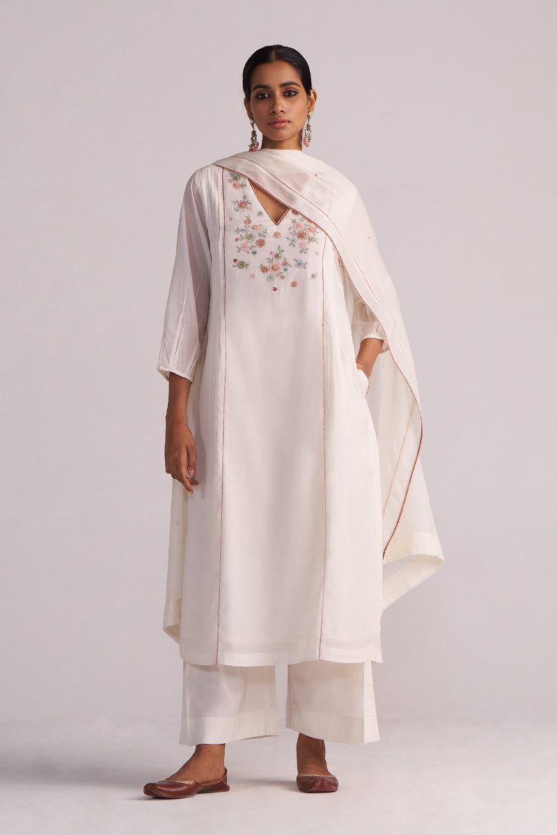 Woman wearing a Ivory Embroidered Kurta Set on a plain background