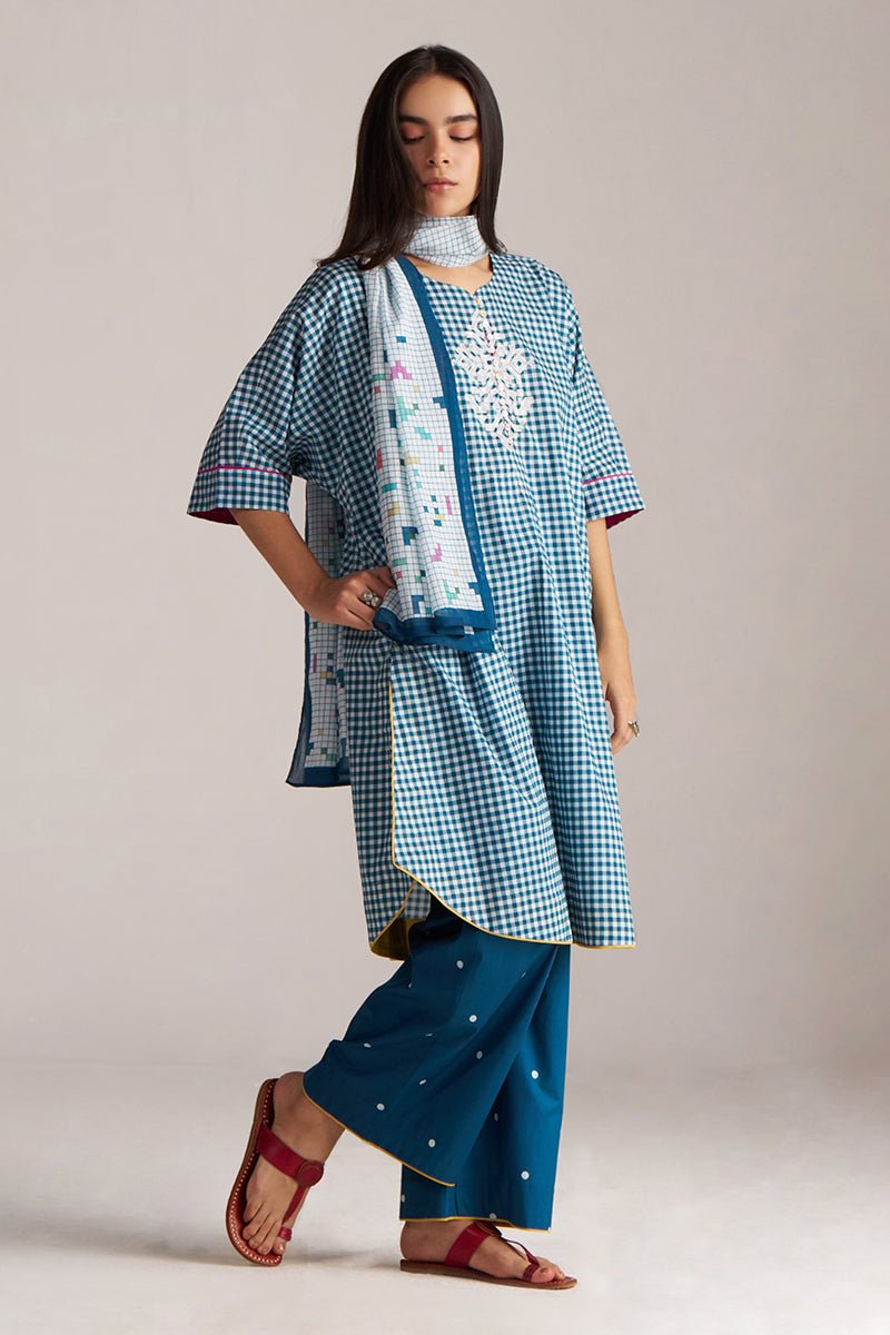 Woman wearing a blue checkered outfit with a scarf, standing against a plain background | Blue and White Mul Mul Checkard Co Ord Set with Stole