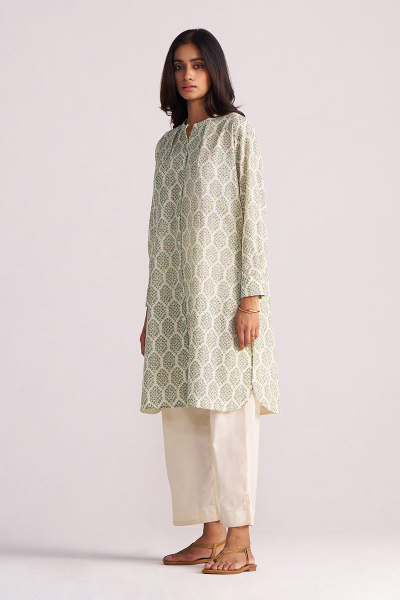 Woman wearing a Cream and Deep Olive Mughal Tree Hand Print Cotton-Linen Co-ord Set on a plain background