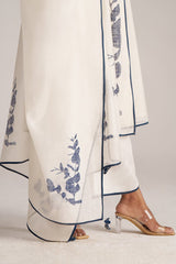 White pants with blue floral embroidery and clear high-heeled shoes on a light gray background | Ivory and Navy Blue Pure Chanderi Kurta Set