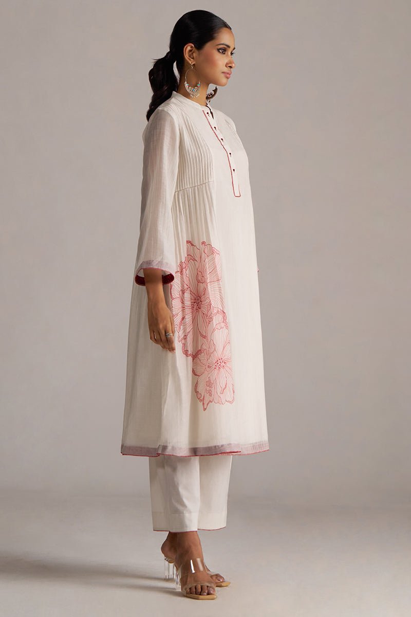 Woman wearing a white kurta with pink floral details on a plain background | Buy Ivory and Maroon Pure Chanderi Kurta Set - Ganga Fashions
