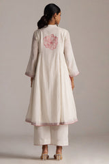 Woman wearing a light-colored kurta with floral embroidery on a plain background | Buy Ivory and Maroon Pure Chanderi Kurta Set - Ganga Fashions