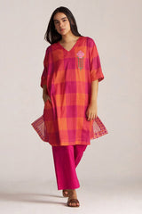 Woman wearing a pink and orange checkered outfit with a white background | Tomato and Fuchsia Mul Mul Co Ord Set