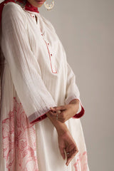 Woman wearing a white and red traditional outfit with floral patterns on a plain background | Buy Ivory and Maroon Pure Chanderi Kurta Set - Ganga Fashions