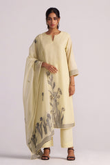 Woman wearing a Butter Yellow Chanderi Woven Kurta Set with a matching dupatta featuring black floral patterns on a white background