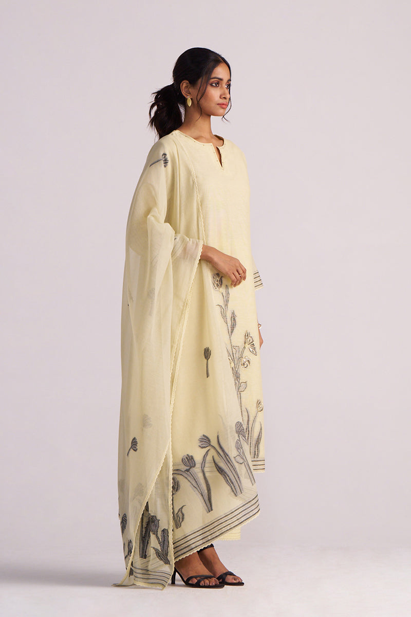 Woman wearing a Butter Yellow Chanderi Woven Kurta Set with floral patterns on a plain background