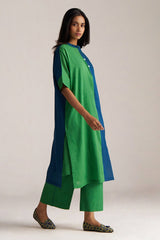Woman wearing a green and blue outfit on a plain background | Blue and Green Mul Mul Co Ord Set