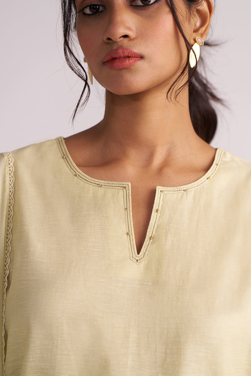 Woman wearing a Butter Yellow Chanderi Woven Kurta Set with a plain background
