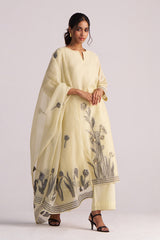 Woman wearing a Butter Yellow Chanderi Woven Kurta Set with floral patterns on a plain background