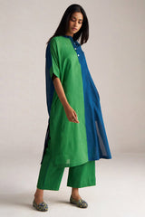 Woman wearing a green and blue outfit on a plain background | Blue and Green Mul Mul Co Ord Set