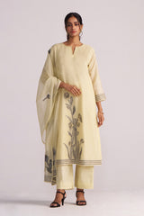 Woman wearing a Butter Yellow Chanderi Woven Kurta Set with floral patterns on a white background