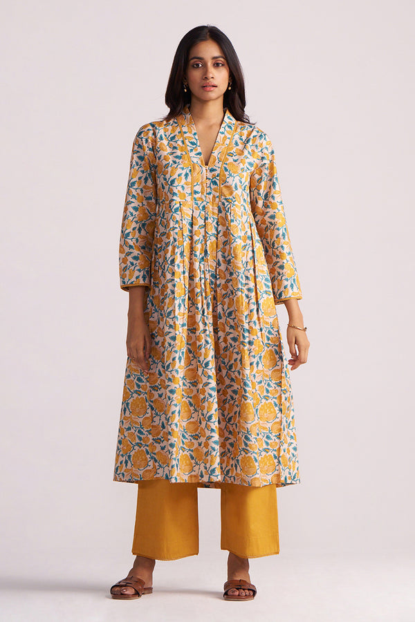 Woman wearing a Beige and Mustard Cotton Print Co-ord Set on a light gray background